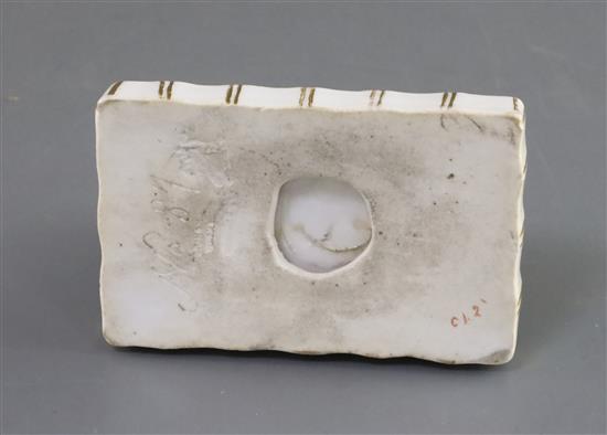 A Rockingham porcelain figure of a recumbent terrier, c.1830, L. 9.7cm